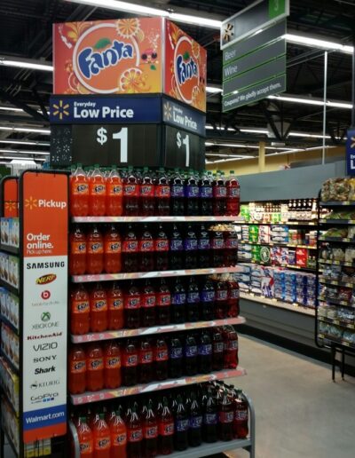 Fanta soda display in a store featuring multiple flavors and a low price sign.